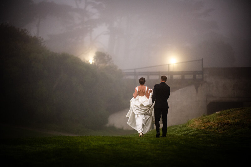 Romantic San Francisco wedding photography in misty park with dramatic lighting and urban backdrop