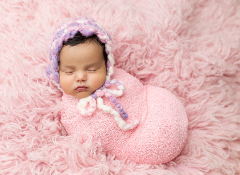 newborn girl on pink flokati