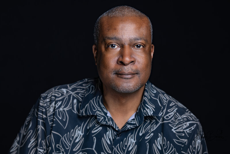 Professional headshot portrait of an African American man in a patterned shirt captured in studio by Tytanium3 Photography, Simpsonville and Greenville SC photographer