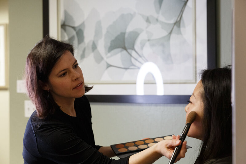 Karyn Carlson applying makeup to a client