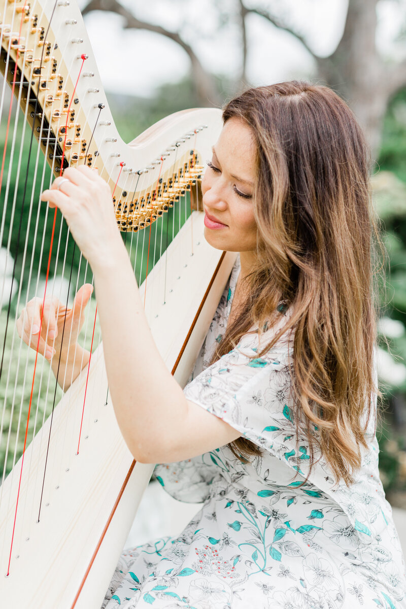 Live harp music adds an ethereal touch to this dreamy outdoor wedding setting.