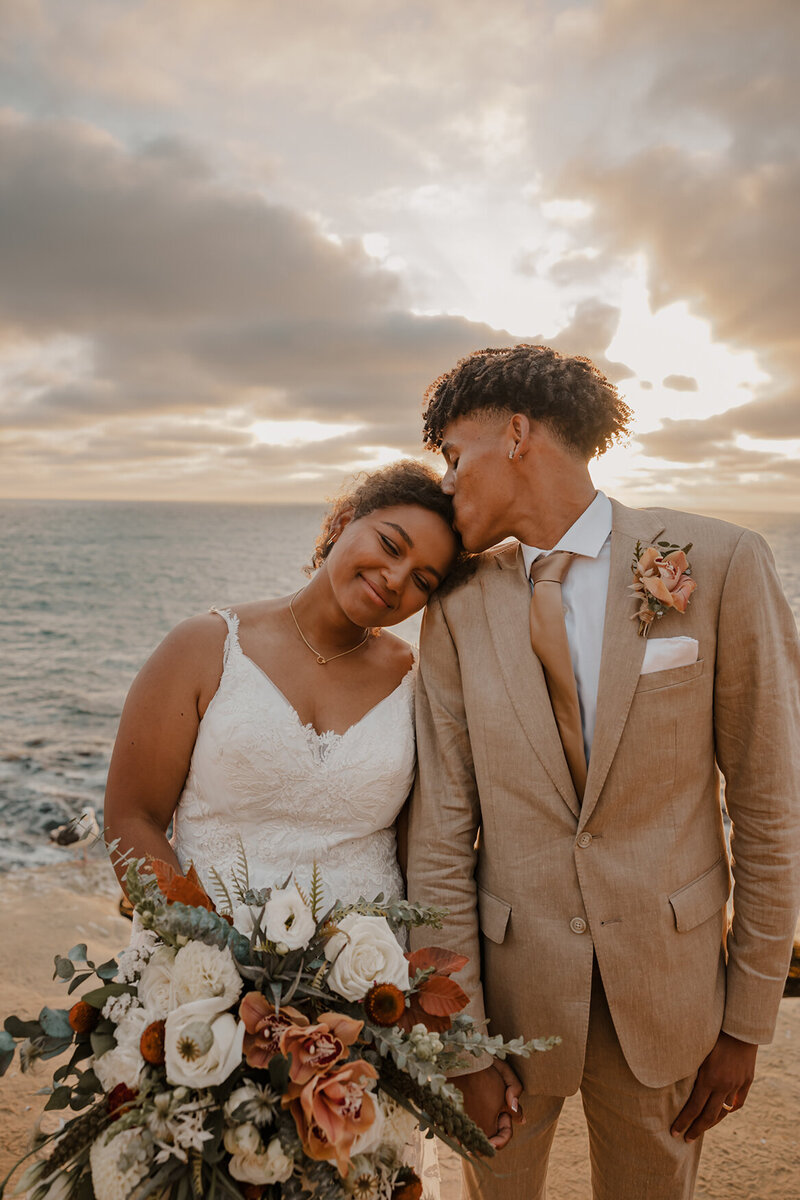 bride and groom in sand