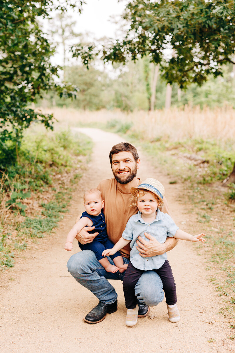 dad with his babies taken by a houston family photographer