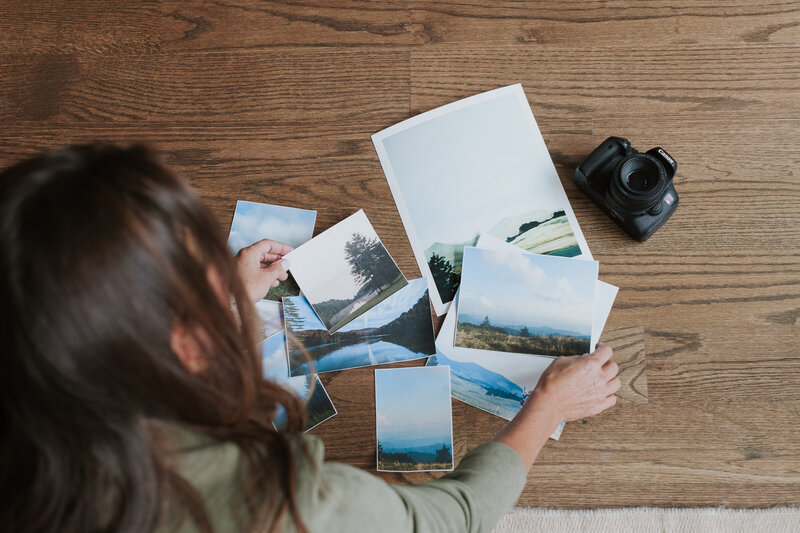 overhead-photo-woman-with-camera-and-printed-photos-for-artist-brand-session-south-charlotte