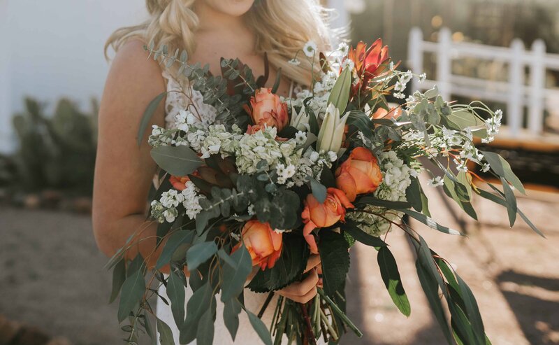 Big Sur wedding photographer captures golden hour portraits of bride holding bridal bouquet