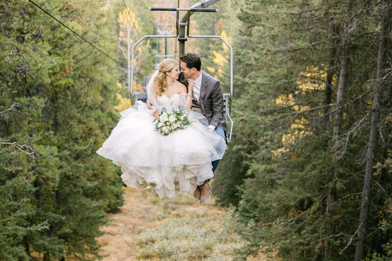 A beautiful moment captured as the bride and groom ride a chairlift at Mount Norquay Ski Resort during their summer portrait session after their wedding.