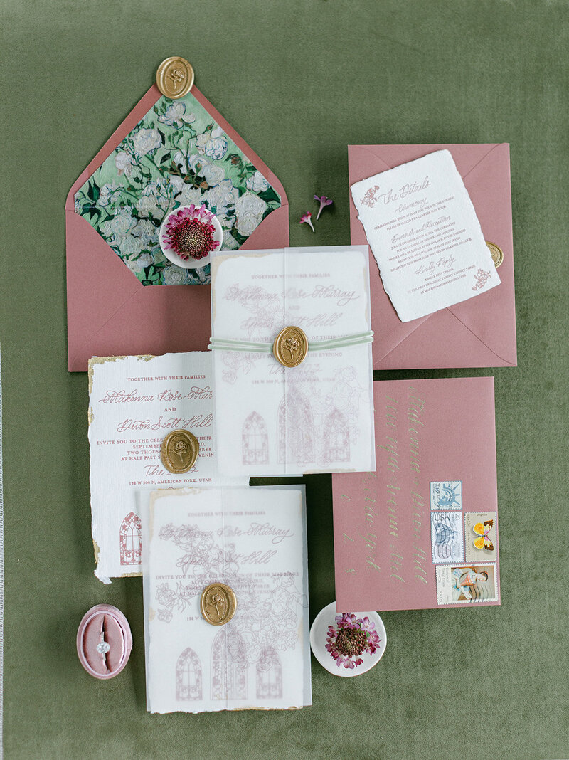 Olive green suede styling mat with wedding details and invitation suite