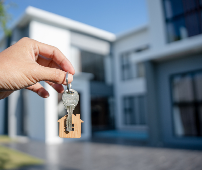 Photo of someone holding keys to a new home.