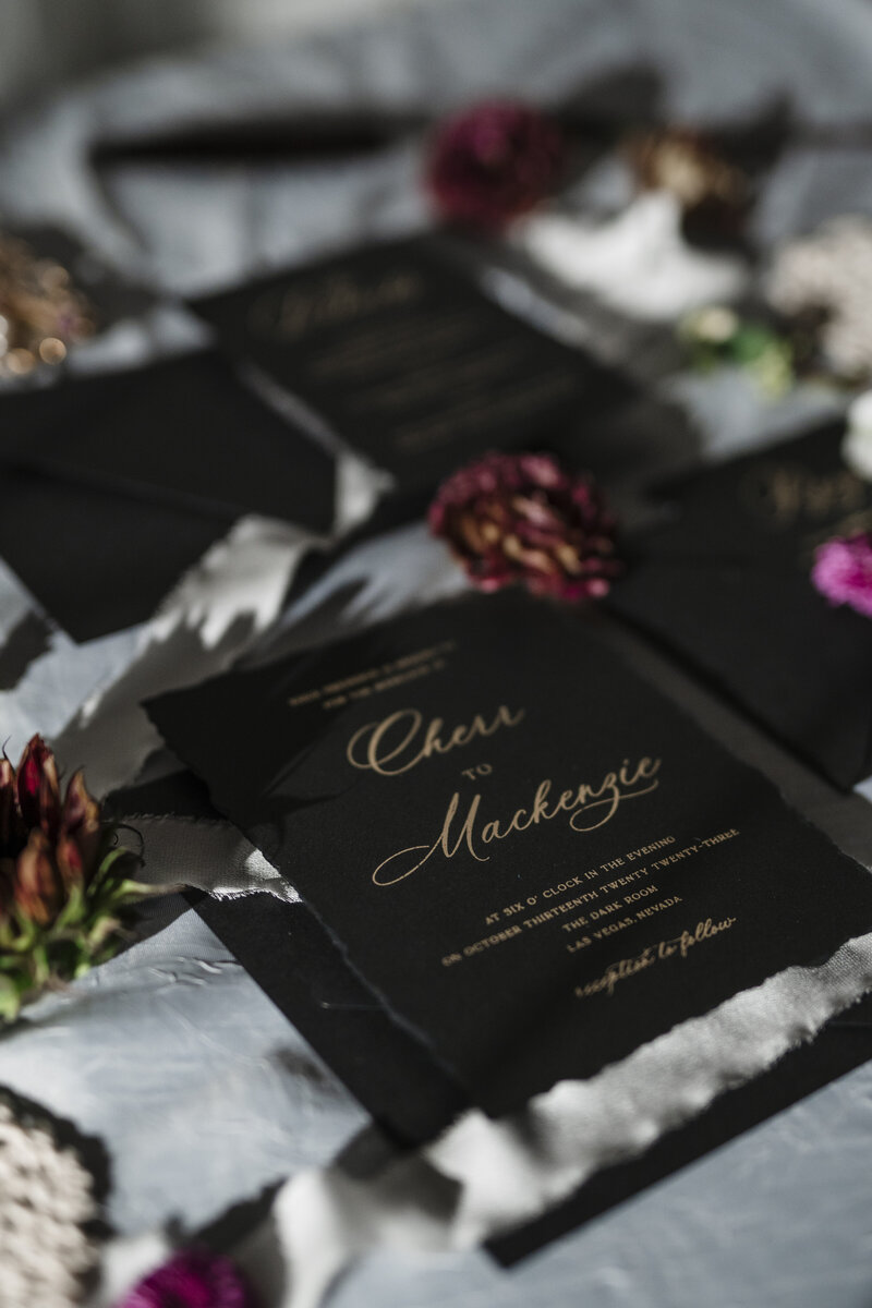An upright elegant place setting with a tan menu with a belly band and wax seal