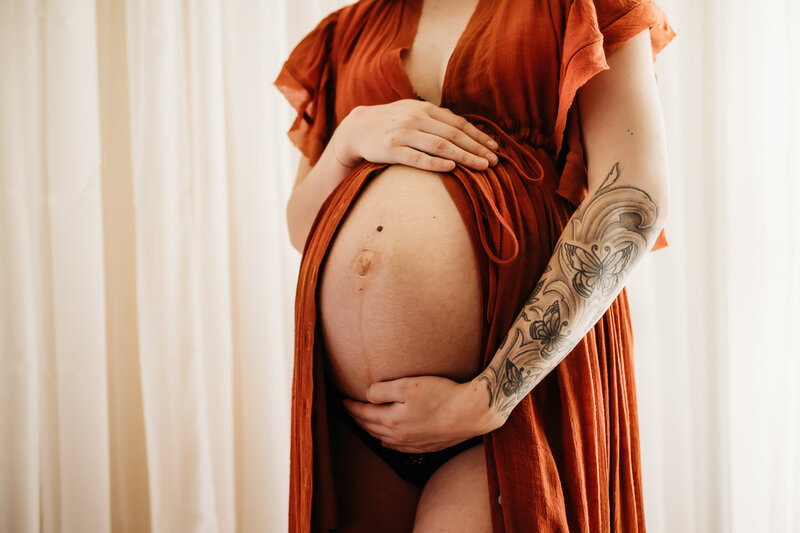 close up of a pregnant belly during a maternity studio session
