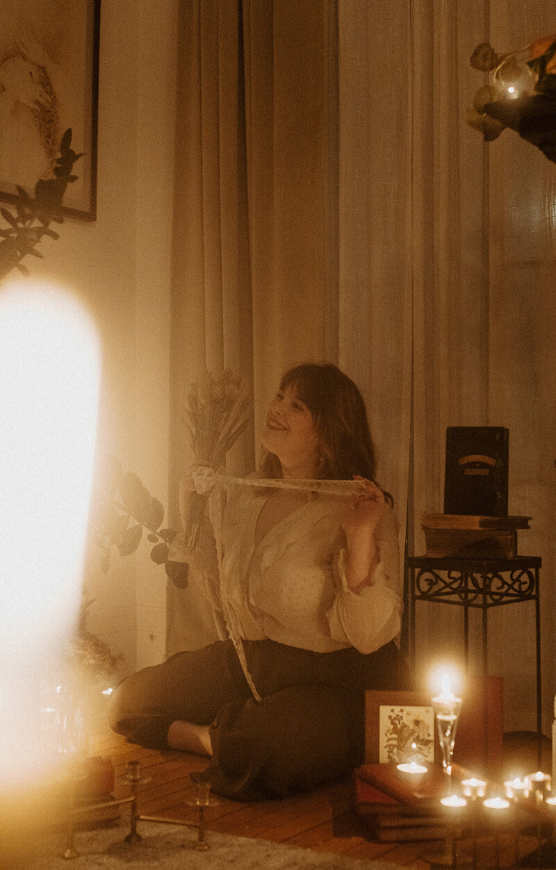 author surrounded by candles and books