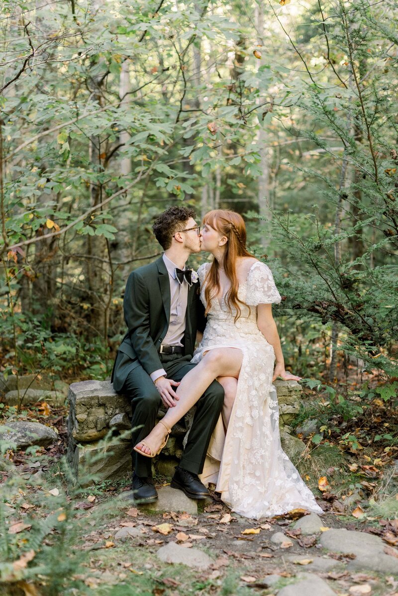 Elkmont elopement couple poses under a canopy of trees in the Smokey Mountains for their couples portraits. 