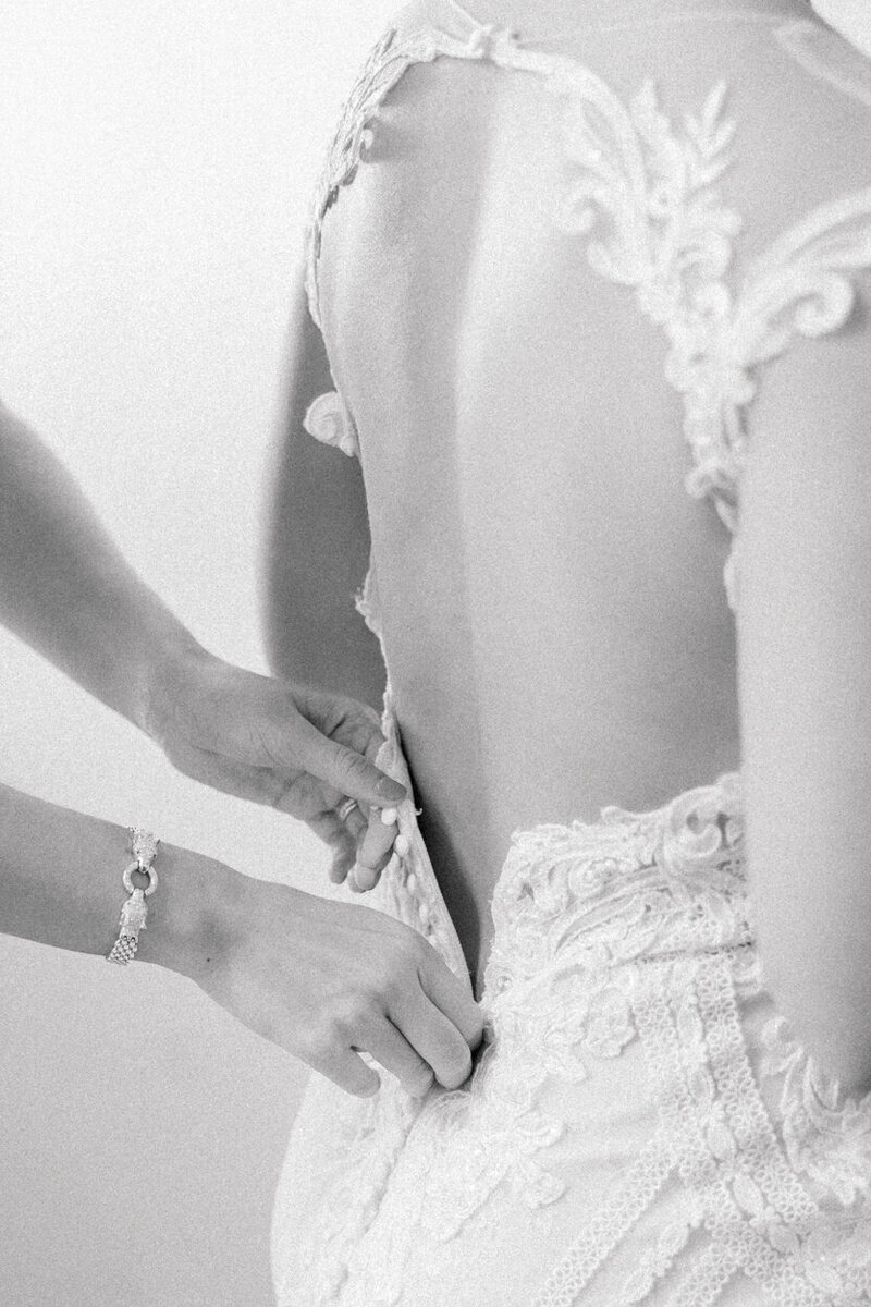 bride's dress getting done up
