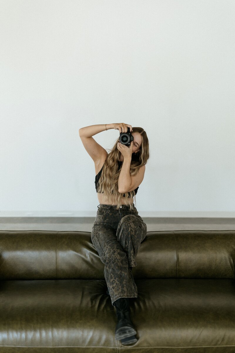 An image of the owner of Courtney Photo & Film sitting on a stool