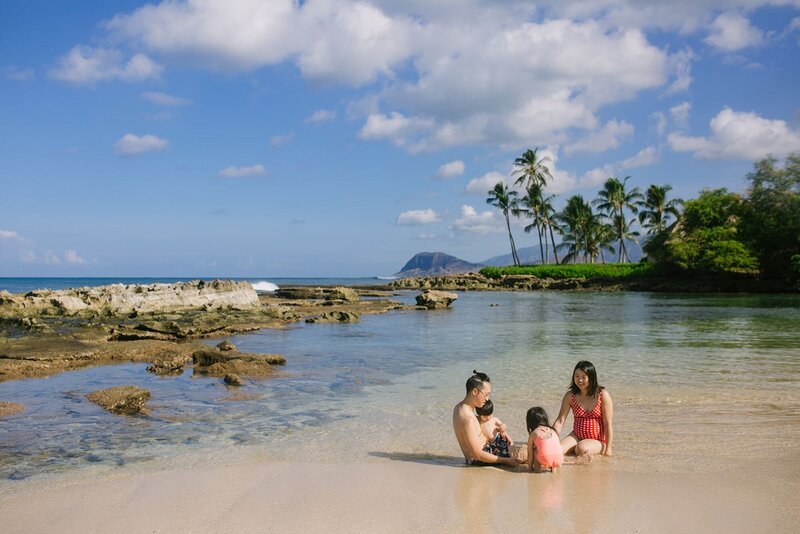 A family place with their two children on the shoreline of Paradise Cove.
