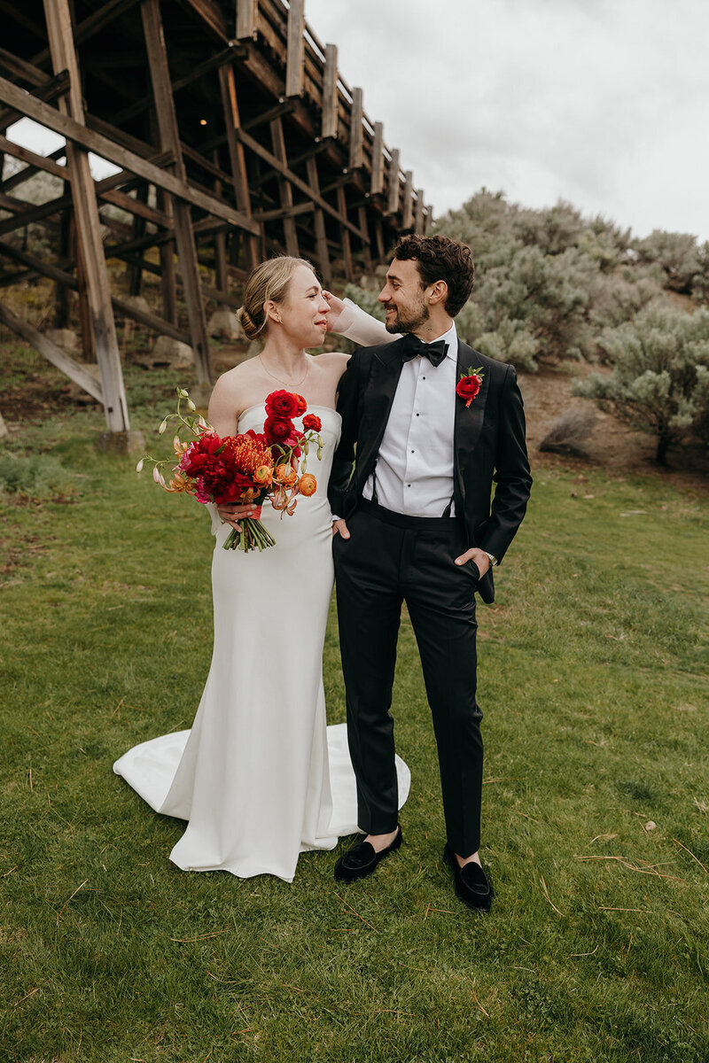 Spring wedding bouquet with protea, lilies, and garden roses