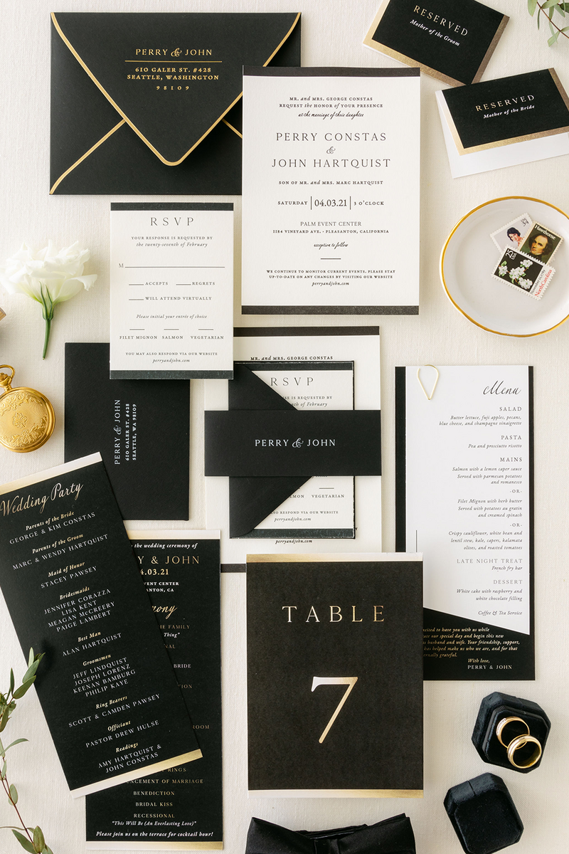 Black letterpress invitation suite with table numbers and menus.