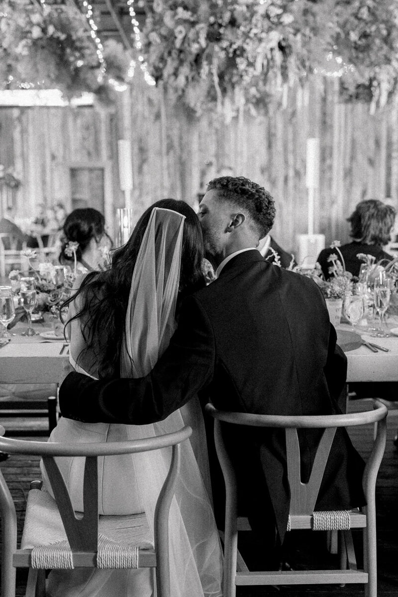 bride and groom sitting at their dinner table