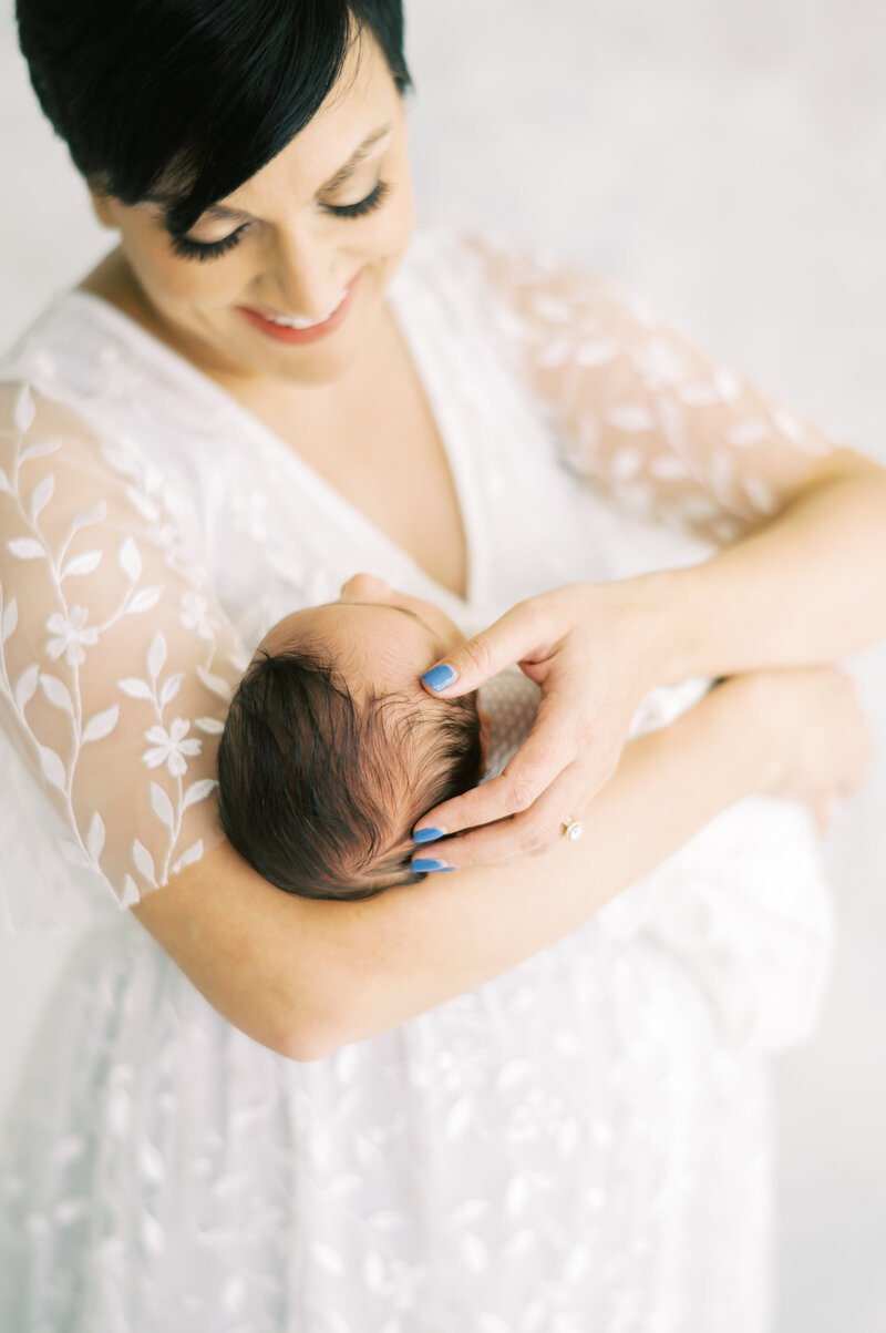 New mother holding newborn baby in Nashville studio