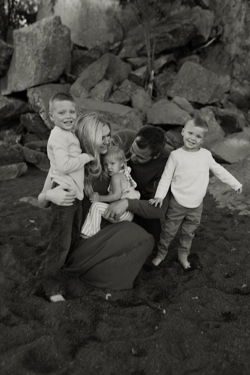 A family of 5 cozies up on Black Beach in Silver Bay, Minnesota during a summer family session.