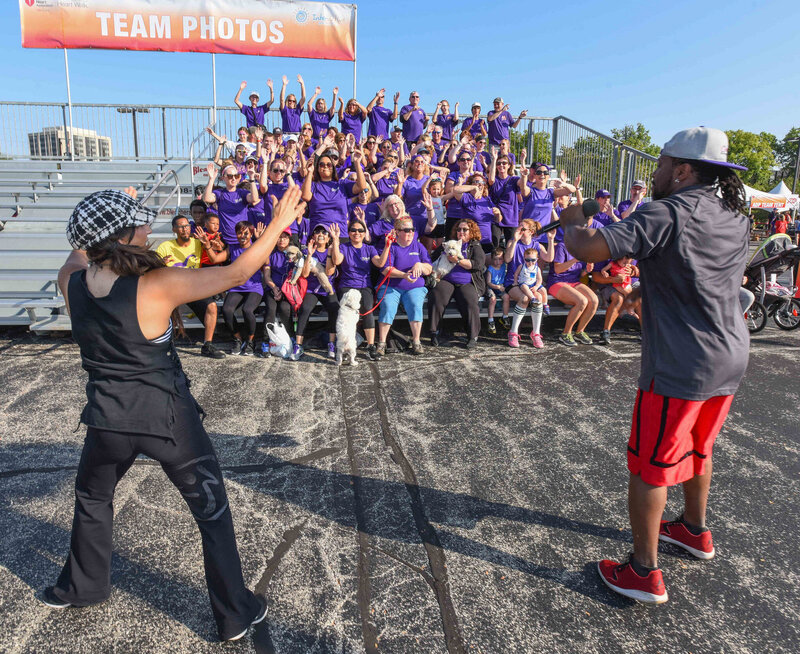 DJ Marz performing in front of people wearing purple shirt