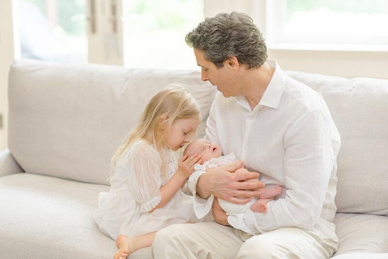 sibling kisses baby during Herndon, Virginia newborn picture