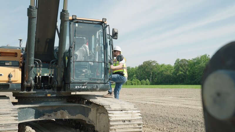 Marty climbing into excavator