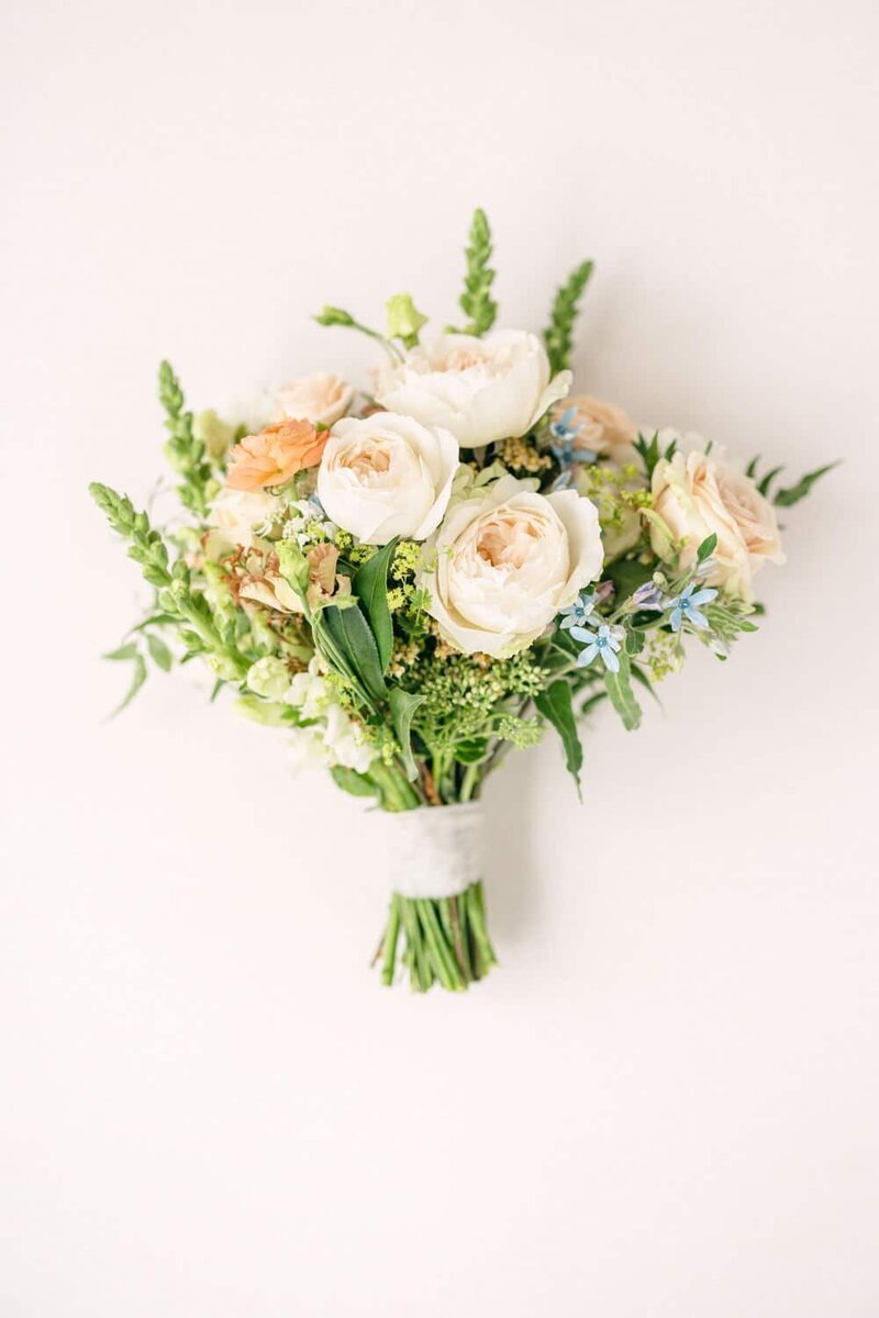 A stunning lay-flat photograph of a bride’s bouquet, beautifully arranged for her wedding day at the Maple Leaf in Banff.