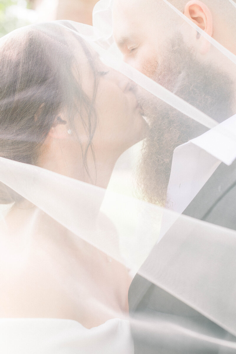 montana bride and groom kissing under the veil