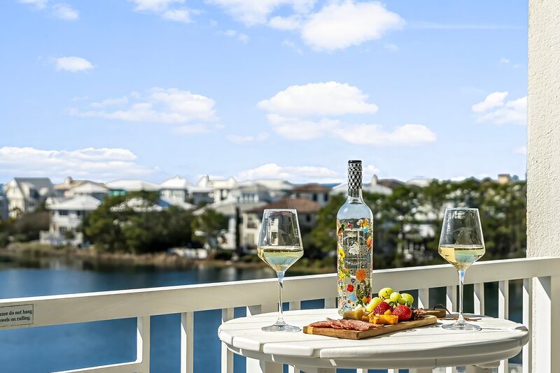 white table with wine and cheese board overlooking Lake Carillon