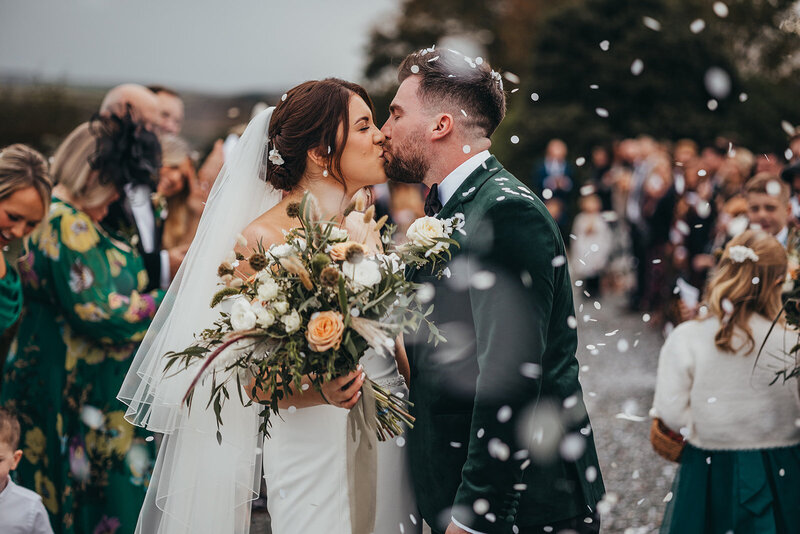 couple share kiss under confetti