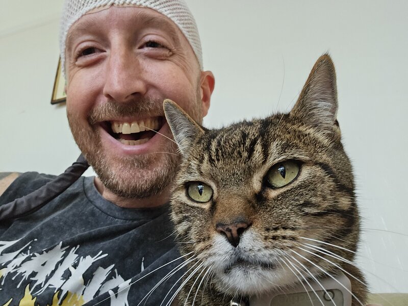 Rick and his cat while wearing the Optune Device