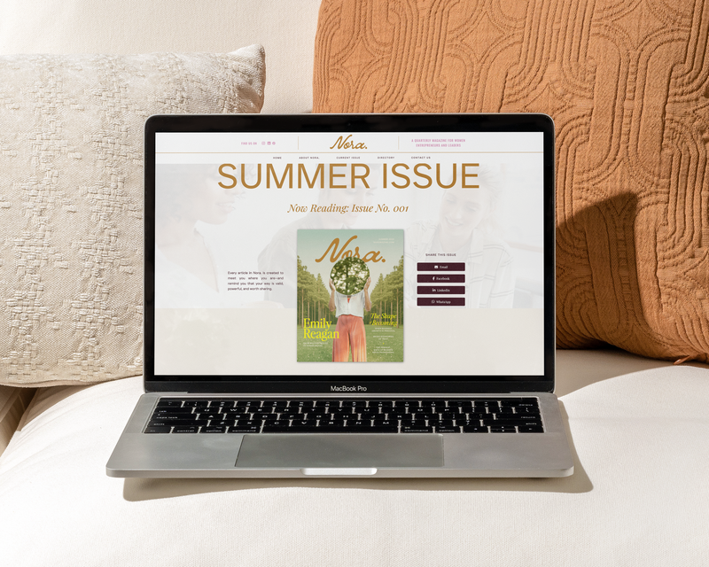 Laptop sitting on couch with screen showing the cover of the Summer issue of Nora. Magazine for female founders.