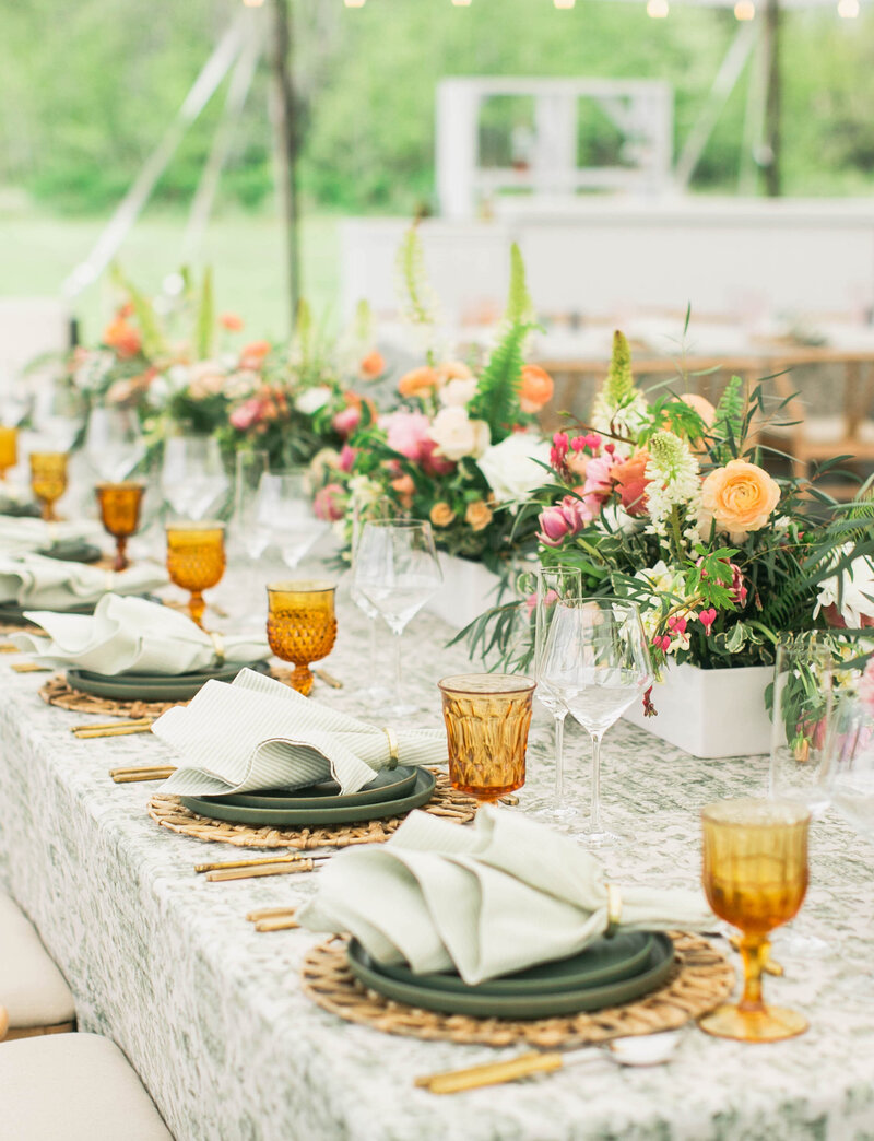 table setting with green plates and flowers