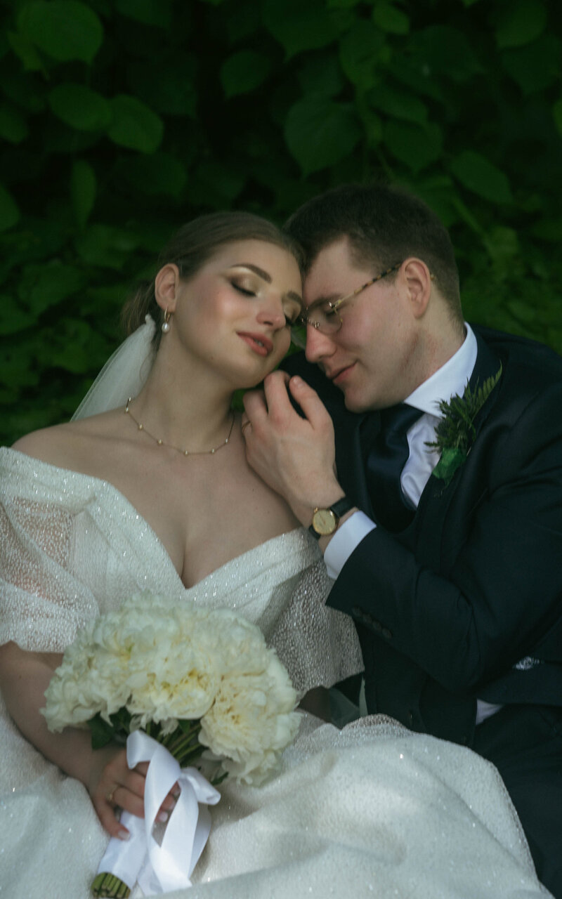 A tender and intimate moment captured as the husband gently touches his wife’s cheek, showcasing their deep love and affection