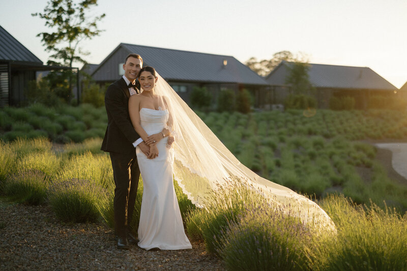 Bride in white lace wedding dress against black background at Lake Como Wedding