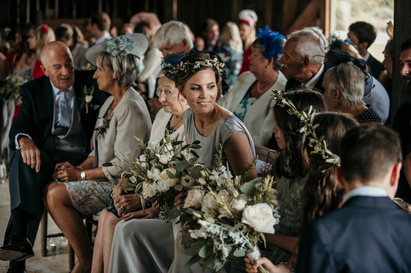 Bridesmaids holding flowers with hair flowers at Nancarrow Farm