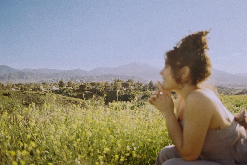 Photographer Puerto Rico in wildflower field during session

