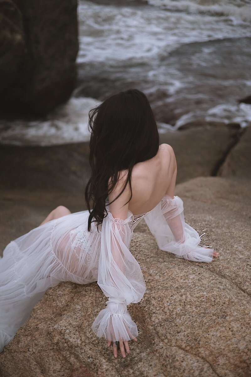A beautiful windswept beach couture shoot amongst coastal rocks.