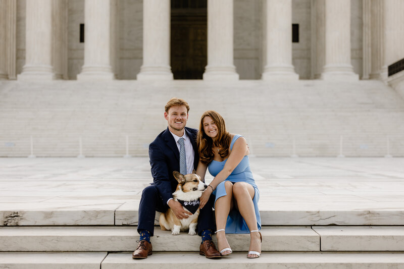 A couple in front of a landmark in DC with their dog, portrait captured by Brandgo Photography