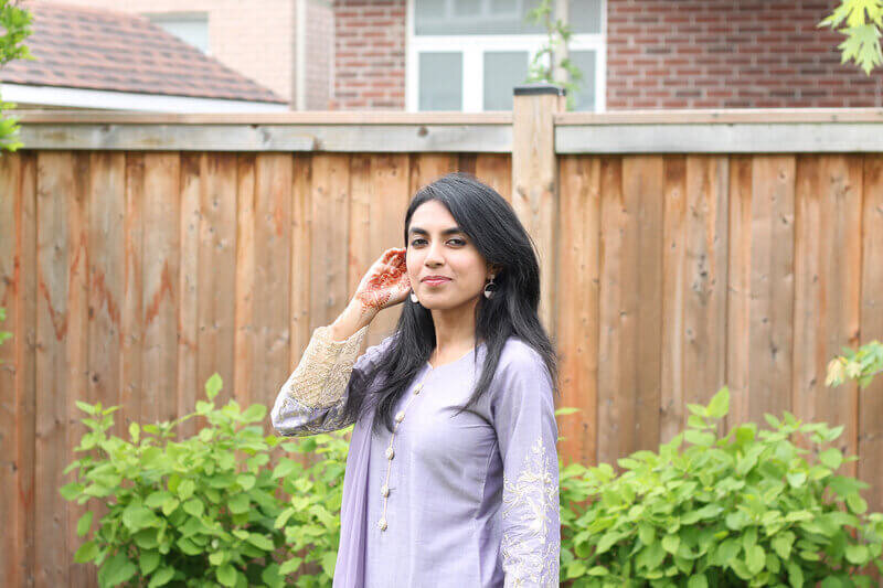 Sarah Khan, a copywriter for small businesses, looking at camera