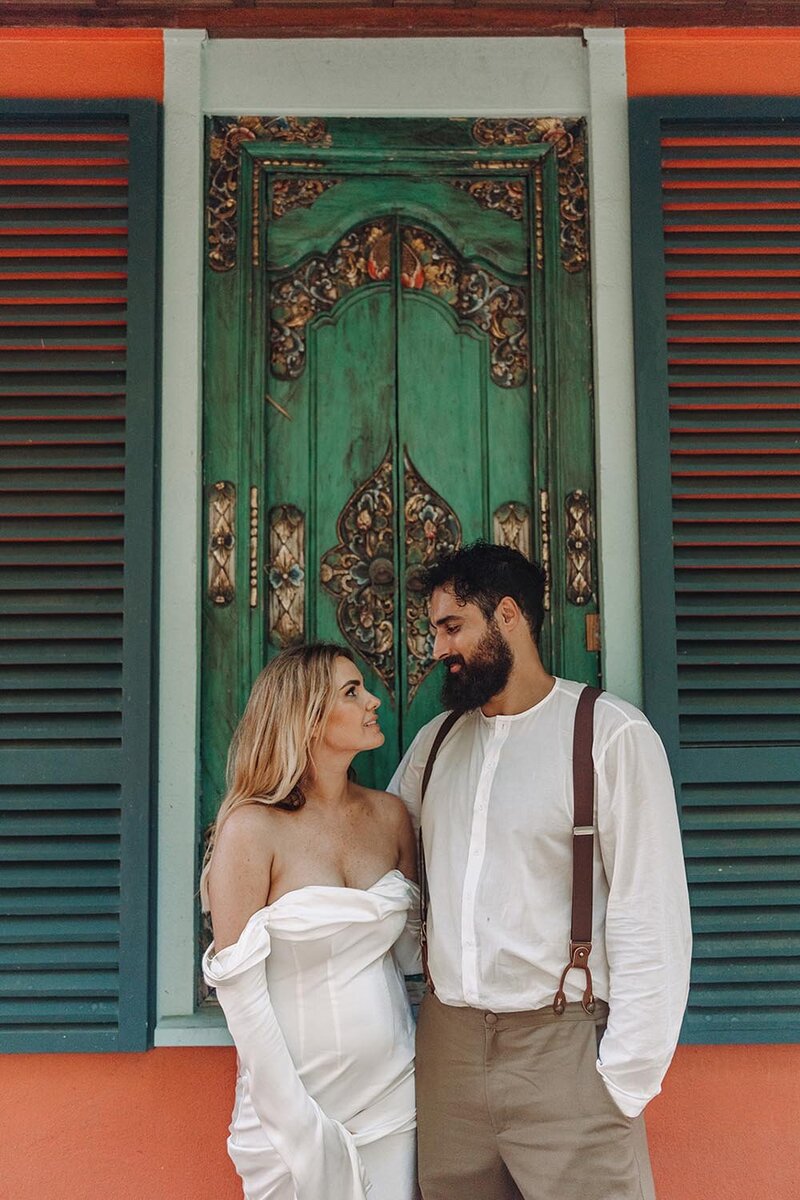 C&A-bride and groom looking at each other in front of a beautiful door