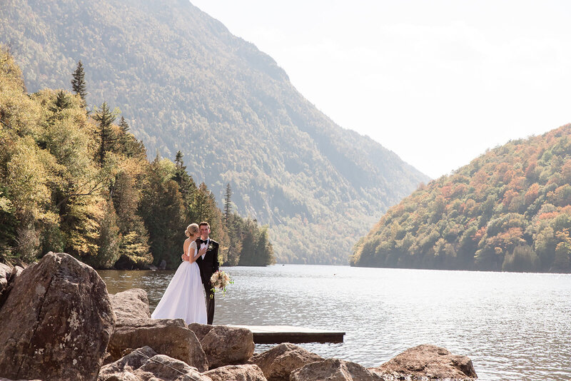 Northern Lake George Yacht  Club wedding on the shores of the lake couple kissing 
