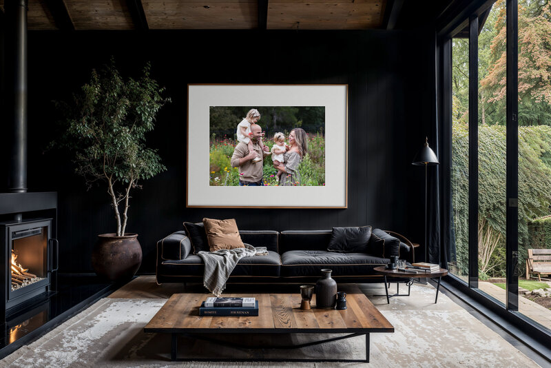 Family custom framed portrait hanging in modern living room.