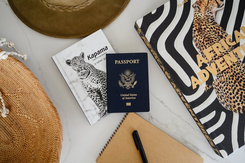 Passport next to a travel guide and travel book about Africa