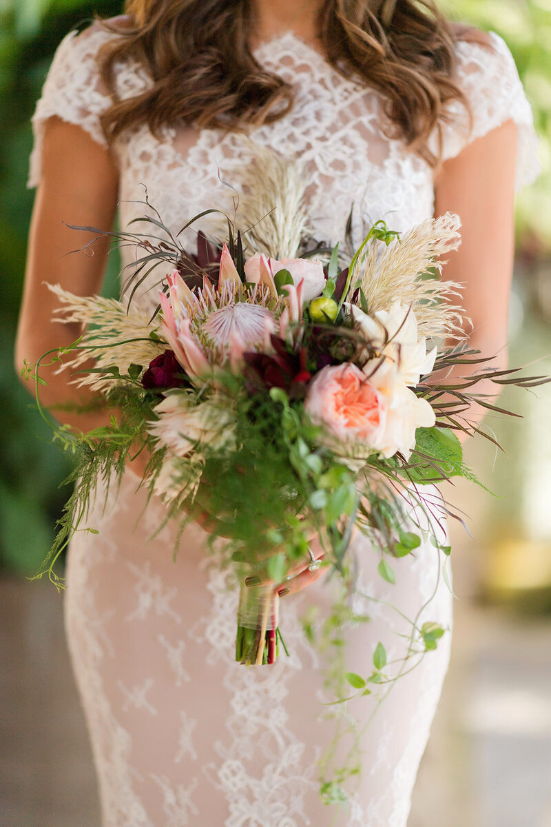 luxury bride poses with high end floral  arrangement