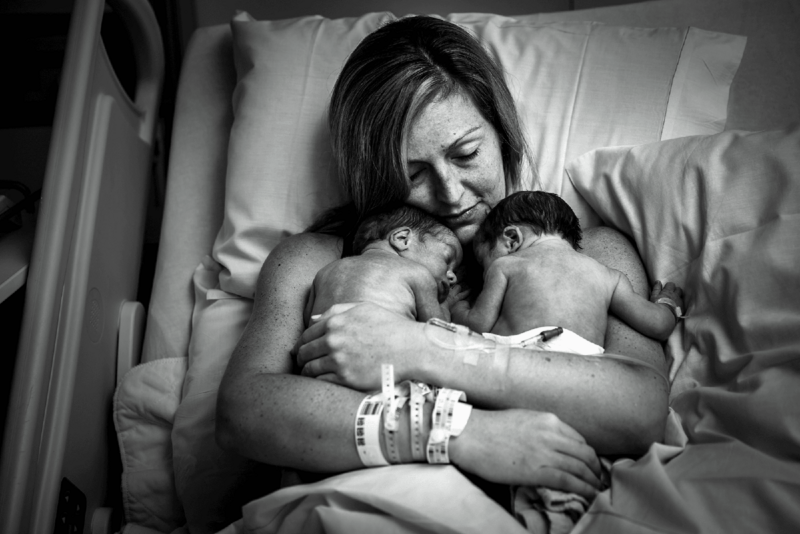 Mother in hospital holding her newborn twins, image by Atlanta commercial photographer Neely Ker-Fox