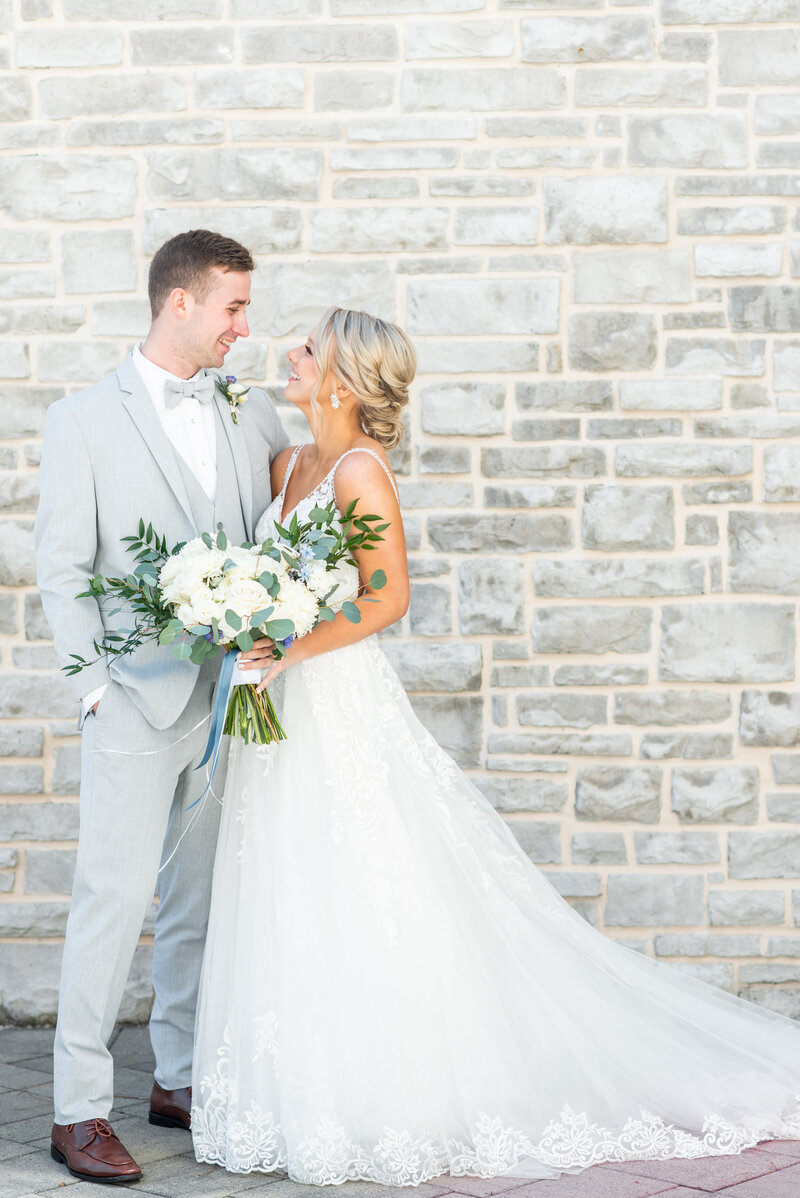 bride and groom looking at each other and smiling