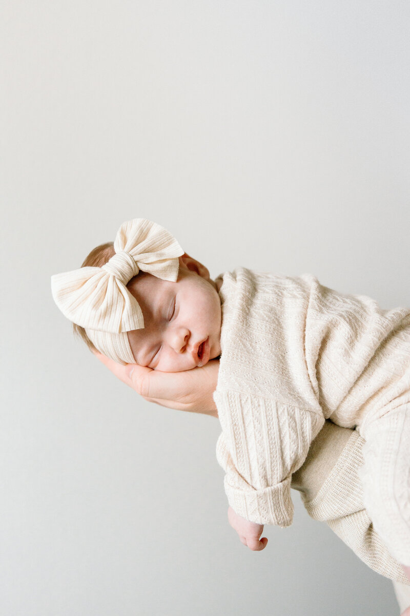 arkansas studio newborn session with baby sleep and laying on moms arm
