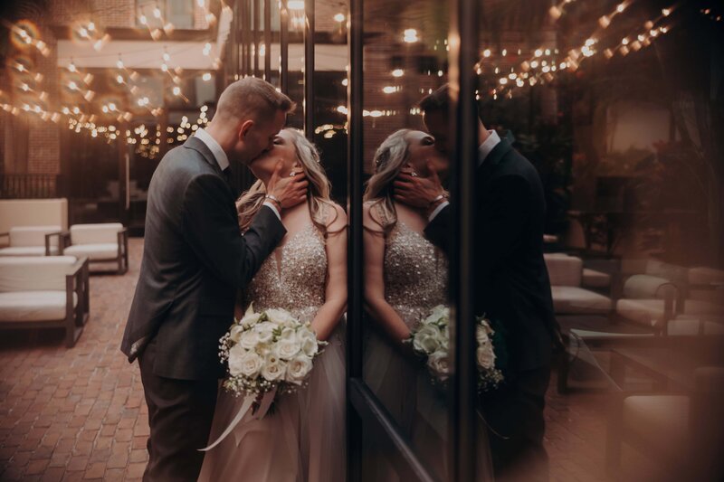 A bride and groom kiss during wedding portraits at Hotel Haya, a Tampa, Florida historic wedding venue by Angela Moon Photography. 